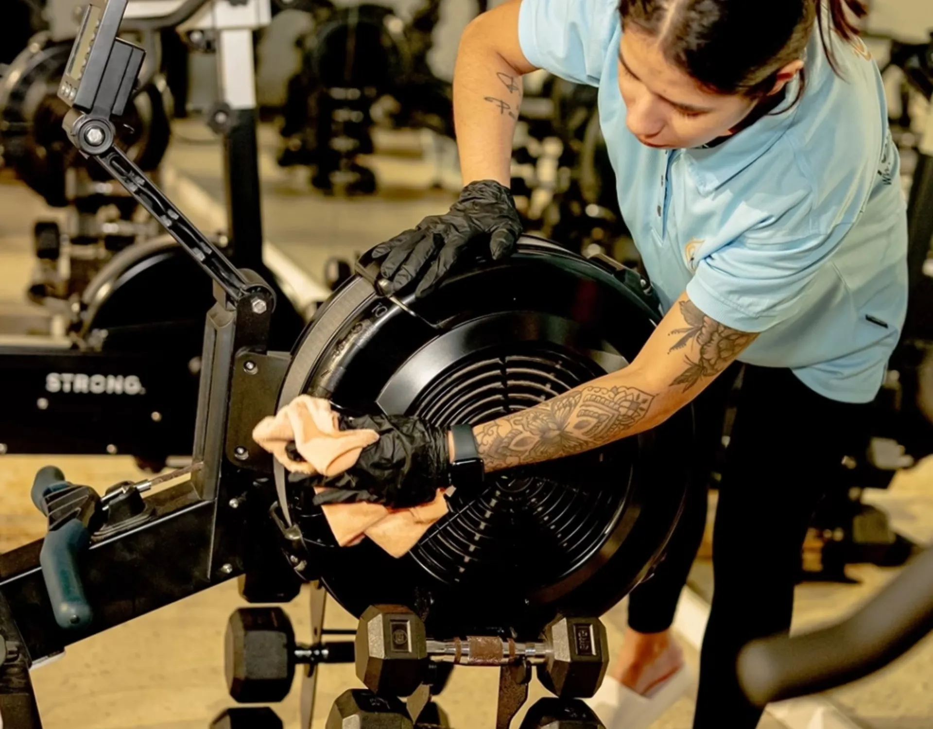 Gold Keys cleaner doing gym cleaning on the Gold Coast, sanitising equipment